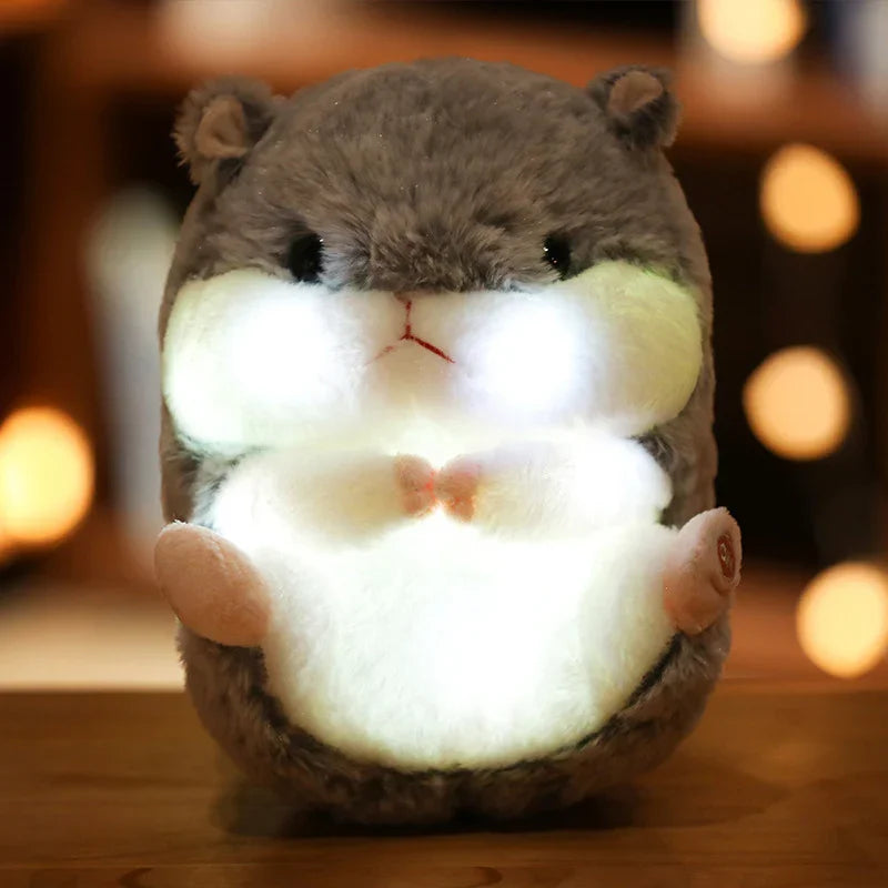 Peluche lumineuse en forme d'hamster gris avec joues et ventre éclairés, ambiance chaleureuse